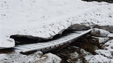 Dřevěný mostek u Trkače v Rudné rokli poškodil nápor sněhu, jeden z nosníků se...