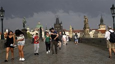 Turisty na Karlov most v Praze náhlá bouka s prtrí mraen nepekvapila....