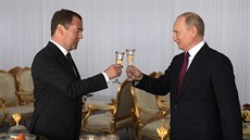 Ruský prezident Vladimir Putin si pipíjí s premiérem Dmitrijem Medvedvem u...