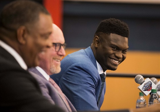 Zion Williamson se usmívá na tiskové konferenci v New Orleans, doprovodili ho...