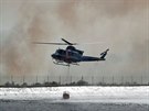 Vrtulník dopluje vodu na haení rozsáhlých lesních poár na severu panlska....