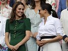 Kate, Duchess of Cambridge and Meghan, Duchess of Sussex, right, stand together...