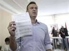 Ruský opoziní lídr Alexej Navalnyj ukazuje novinám volební lístek ve volební...