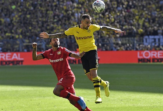 Paco Alcacer z Dortmundu (ve lutém) hlavi&#269;kuje v utkání proti...