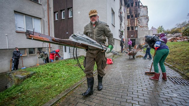 Po explozi a poru v dom v Lenoe pomhaj lid s klidem okol i sousednch byt (5. jna 2019).