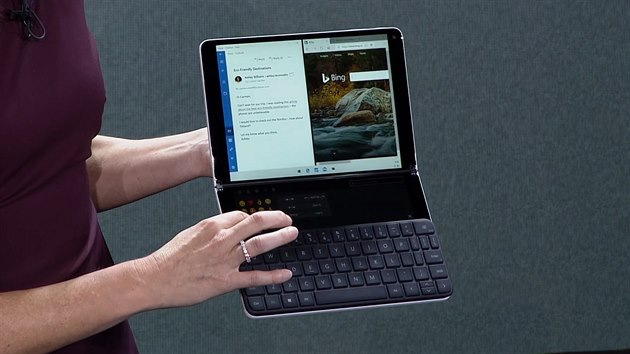 Aplikace na hornm a nabdka s jejich menu na spodnm displeji s pipnutou klvesnic u notebooku Surface Neo