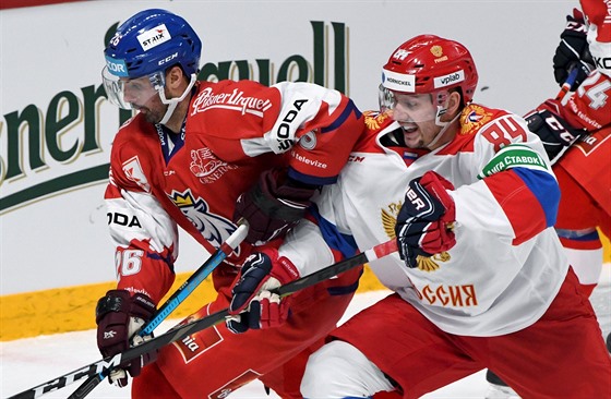 Český hokejista Michal Řepík (vlevo) a Rus Pavel Kudrjavcev bojují o puk.