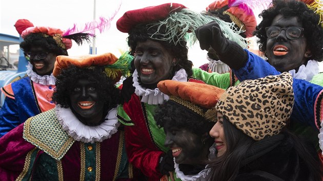 ena pzuje s pomocnky svatho Mikule. Zwarte Piet podle oponent podporuje rasistick stereotypy.
