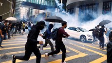 Demonstranti v Hongkongu prchají ped policisty, kteí proti nim pouili slzný...