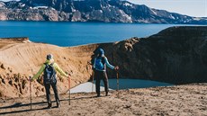 Turisté stojí nad kráterem islandské sopky Askja.