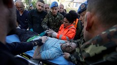 Záchranáři pomáhají zraněnému muži po zemětřesení v Albánií. (26. listopadu...