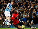 Aaron Wan-Bissaka z Manchesteru United (vpavo) padá na trávník po souboji s...