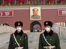 Policisté s rouškami před podobiznou Mao Ce-tunga v Pekingu (27. ledna 2020)
