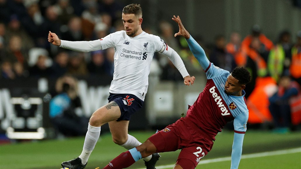 Jordan Henderson (vlevo) z Liverpoolu se zkou�í protáhnout p�es Sebastiena...