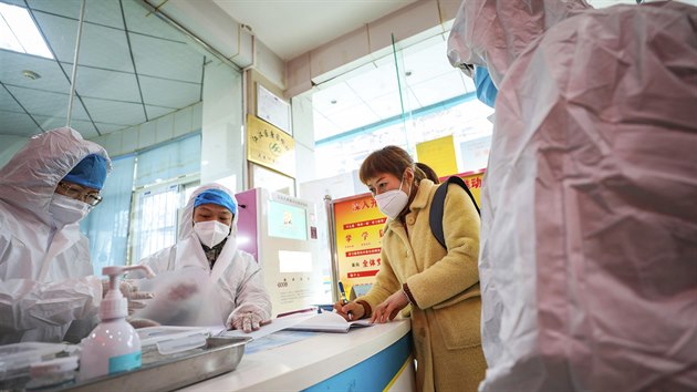 Bezpenostn tm kontroluje enu s podezenm na nkazu koronavirem ve zdravotnickm centru msta Wu-chan. (27. ledna 2020)