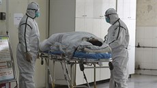 Zamstnanci nemocnice pebírají nakaeného koronavirem v ínském mst Fuyang....