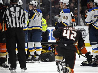 Vince Dunn z St. Louis si zakrývá obličej, Josh Manson z Anaheimu klečí....