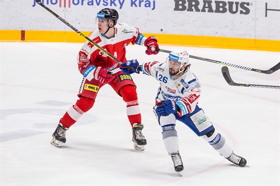 Martin Zaovi z Brna (vpravo) sleduje hru, za ním bruslí olomoucký Adam Rutar.