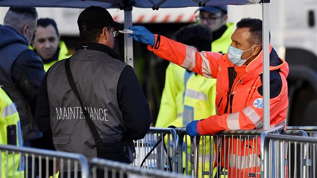 Zdravotník měří teplotu muži před vchodem na fotbalový stadion Juventusu Turín. (8. března 2020)