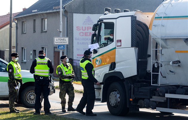 Kontrolní místo policie a vojenské policie na okraji uzavené zóny u obce...