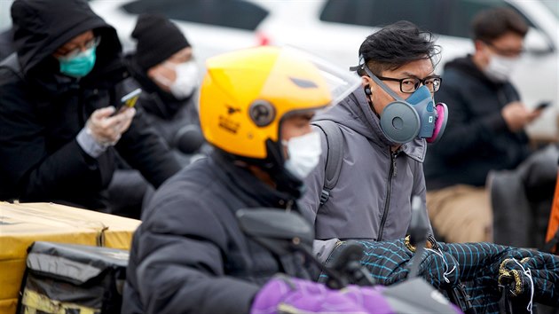 Lid v ochrannch roukch bhem rann dopravn piky v Pekingu (9. bezna 2020)
