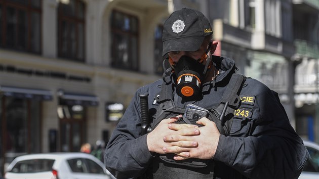 Policista hldkuje se specilnm respirtorem v centru Prahy. (14. bezna 2020)