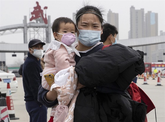 Žena s dítětem v roušce v čínském Wu-chanu (3. dubna 2020)