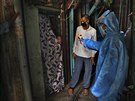 Doktor kontroluje teplotu dívky v jednom z nejvtích asijských slum Dharavi v...