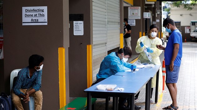 Singapurt zdravotnci vyetujc zahraninho pracovnka v ubytovn pro migranty. V tch se v posledn dob rozil koronavirus. (7. dubna 2020)