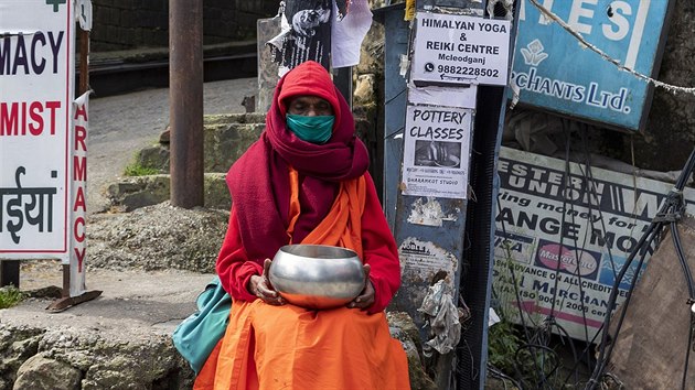 Buddhistick mnich v rouce sed na nmst a ebr o almunu v Dharmsale v Indii. (20. dubna 2020)