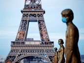Zlaté sochy na náměstí Trocadero před Eiffelovou věží ozdobené rouškami. (14....