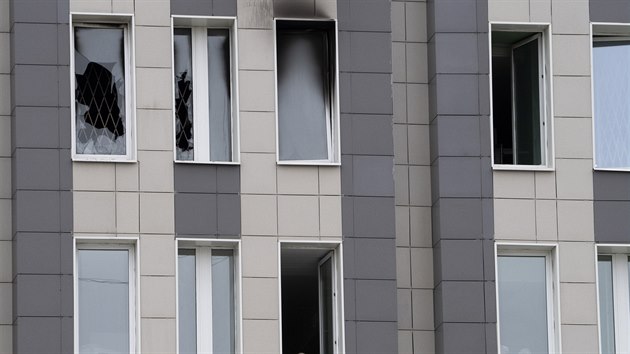 A member of the medical staff, bottom, looks through an open window next to the scene of a fire at St. George Hospital in St. Petersburg, Russia, Tuesday, May 12, 2020. A fire at St. George Hospital has killed five coronavirus patients. Russian emergency officials said all five had been put on ventilators. The emergency officials told the state Tass new agency the fire broke out in an intensive care unit and was put out within half an hour. (AP Photo/Dmitry Lovetsky)
