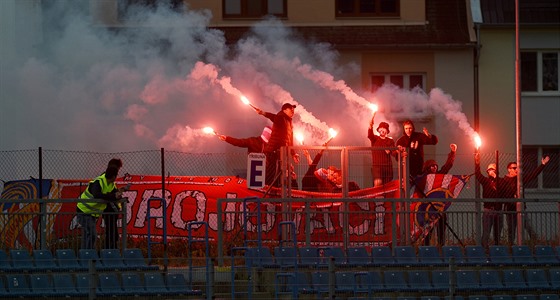 Fanouci Brna fandí svému týmu za plotem stadionu v Ústí nad Labem.