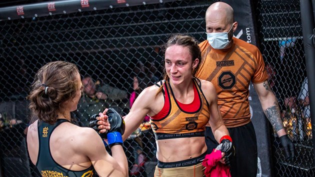 MMA z�pasnice Tereza Bled� d�kuje za z�pas soupe�ce Lucii Pudilov� (v oran�ov�m). Za nimi stoj� Pudilov� tren�r Ladislav Erd�lyi na turnaji Oktagon Underground.