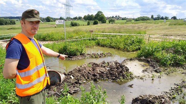 Vedoucí týmu archeolog Jakub Tsnohlídek ukazuje na jámu s navezenou...