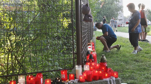 Lid zapaluj svce na pietnm mst k uctn pamtky obt poru naproti panelovho domu v Bohumn. (9. srpna 2020)