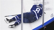 Obránce Jake Muzzin z Toronto Maple Leafs leží na ledě po nárazu do hlavu.