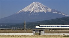 Mount Fuji with Shinkansen bullet train passing through rice fields. Japan...