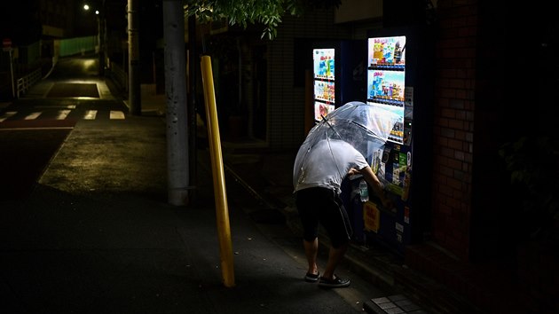 Mu nakupuje v poulinm prodejnm automatu v japonskm Tokiu. (11. ervence 2020)