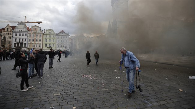 Policisté opakovaně vyzývají všechny, aby opustili pražské Staroměstské náměstí. Zasahují těžkooděnci a ulicích je hodně kouře. Vzduchem lítá všechno, co mají demonstranti po ruce. Dlažební kostky, láhve od piva, plechovky. (18. října 2020)