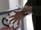 Voli si obléká plastikové rukavice, aby mohl volit v parlamentních volbách v...