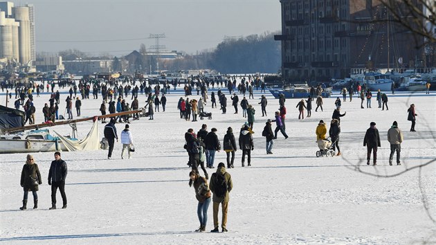 Lidé si užívají slunečný den na zamrzlé řece v Rummelsburger Bay v Berlíně. (14. února 2021)