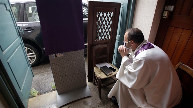 Katolick knz David de Lestapis sed v kostele v Limoges a ek na zjemce o zpov. (2. kvtna 2020)