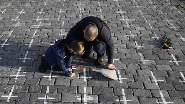 K namalovanm km na pamtku obt koronaviru na Staromstskm nmst v Praze lid spontnn zaali pst jmna svch blzkch, kte zemeli a zapalovat svky. (24. bezna 2021)