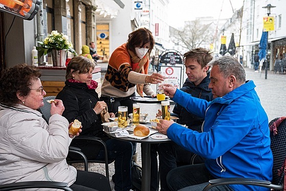 Lidé si dávají oberstvení na zahrádce restaurace v Saarbrückenu ve spolkovém...