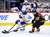Rasmus Dahlin (left) from Buffalo leads the puck, he is attacked by Scott Laughton from ...