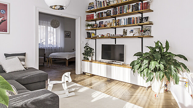 Jednoduše a velmi prakticky je zařízený obývací pokoj. Pohodlnou sedačku doplňuje nízká televizní skříňka a industriální policová knihovna české značky Wuders.