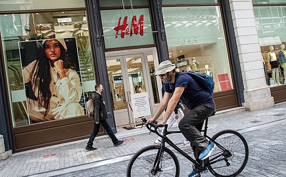 Cyklista projíždí kolem zavřené pobočky oděvního řetězce H&M v řeckých...