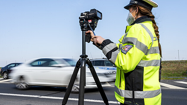 Policistka měří 21. dubna 2021 rychlost vozidel na sjezdu z dálnice D7 u Postoloprt na Lounsku. Místo vybrala policie na základě hlasování občanů. Do celoevropské bezpečnostní akce nazvané Speed Marathon se policejní hlídky zapojily pošesté.