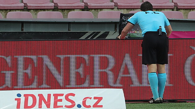 Rozhodčí Ondřej Pechanec si prohlíží na videu penaltový zákrok na sparťana Adama Karabce v utkání s Plzní.